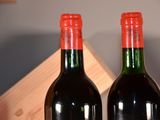two bottles of wine sitting next to each other on a table