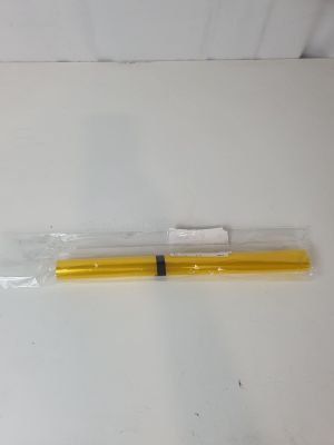 a yellow pen that is sitting on a white table