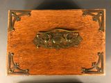an old wooden box with a metal handle on a table