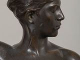 bronze statue of a woman holding a bird in her hand