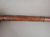a wooden stick with carvings on it sitting on a table