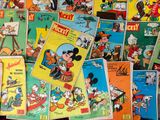 a lot of mickey mouse books on the table