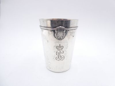 a silver cup with a crown on it on a white surface