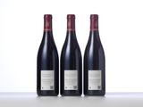 three bottles of wine sitting on top of a table next to each other