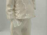 a white statue of a man with a hat on