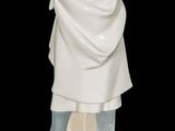 a figurine of a man holding a baseball bat