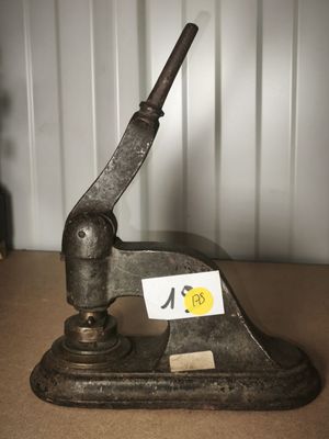 a small metal object on a table with a sticker on it