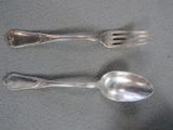two spoons and a fork sitting on a table