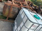 a large metal container sitting on the ground next to other metal containers