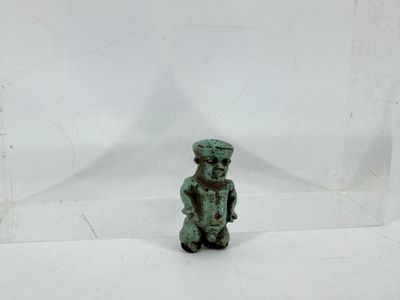 an image of a small green figurine sitting on top of a white surface