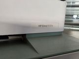 a white laptop sitting on top of a green counter
