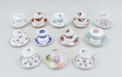 a lot of tea cups and saucers sitting on a table