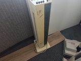 a small air conditioner sitting on the floor next to a wall