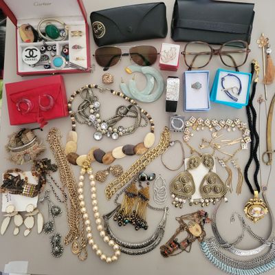 many different types of necklaces and bracelets laid out on a table