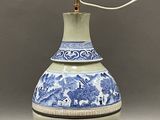 an image of a blue and white vase with a light on top of it