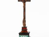 an image of a wooden cross on a pedestal with a green base