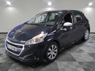 the small black car is parked in a large room