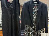 two jackets and a dress on a rack in a store
