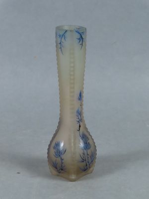 a glass vase that has a blue and white design on it