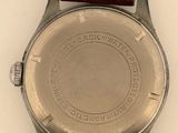 an image of a close up of a watch on a white surface