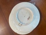 a white plate with writing on it sitting on a wooden table