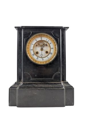 a black and gold clock with a white face