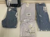 several pairs of men ' s clothing are sitting on a counter