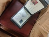 a passport sitting on top of a bed next to a pillow