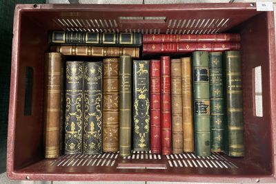many old books in a red box on the floor