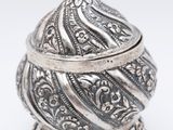 an ornate silver box with a bird on top of it