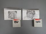 three books on a gray wall with a black and white photo