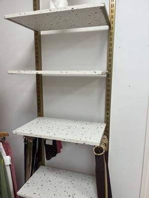 a shelf that has some clothes on it in a room