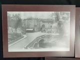 two old black and white photos of a street and a building
