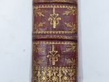 a close up of a book on a white surface with a white background