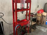 a red machine that is sitting in a garage