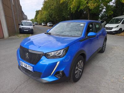 a blue suv parked in a parking lot next to a building