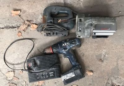 a corded drill and a corded hammer on the ground