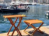 two tables that are sitting on the side of the water