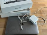 a box with a laptop and a charger on it