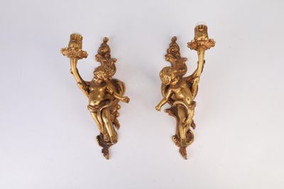 pair of antique brass cherensils with cherensils on them