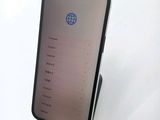 the iphone is sitting on top of a stand on a white surface