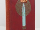 a red book with a picture of a woman standing in front of a tree