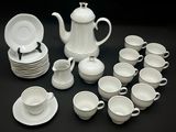 a picture of a white tea set with cups and saucers