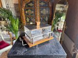 a small glass box on top of a black table