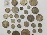 a bunch of coins sitting on top of a white surface