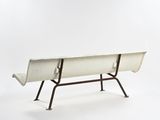 a white bench that is sitting on a metal stand