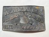 un gros plan d'une plaque métallique posée sur une surface blanche