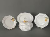 four pieces of porcelain dishes and plates on a gray surface