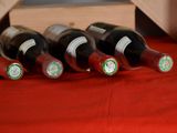 several bottles of wine are lined up in a wooden crate