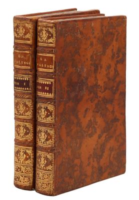 a pair of old books sitting on top of each other
